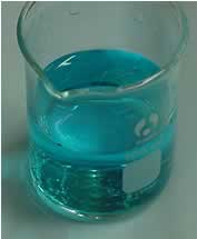 The blue solution of copper sulfate.