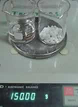 The two beakers on the electronic balance.