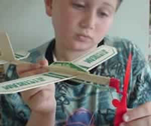 A toy plane changes stored elastic energy into kinetic energy as the propeller spins.