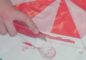 Lay the parachute out and cut along the dotted lines