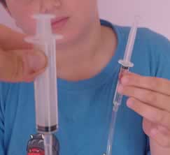 Connect a 2.5ml syringe to a 10ml syringe as shown.