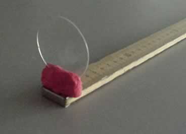 The weak lens fixed to the ruler with plasticine.